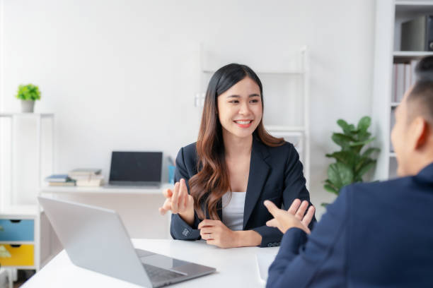 istock Two Young Asian business people discuss with new startup project Idea presentation, analyze planning and financial statistics and investment market at office. 1499376919
