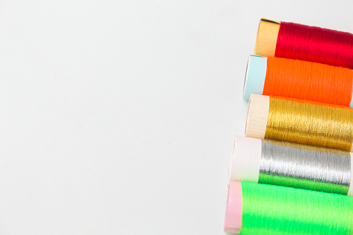spool of colorful thread or string isolated in white and copy space