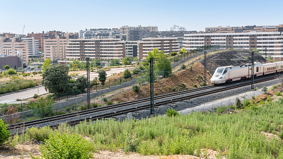 Madrid, Spain, May 27, 2023: Ave high-speed train as it passes through the new neighborhoods of the city of Tres Cantos in Madrid