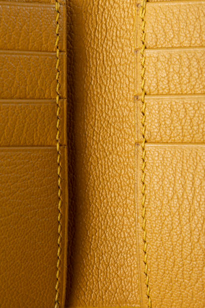 istock Texture of yellow leather close-up with stitching. 1499382946