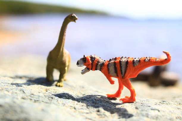 Two toy dinosaurs outside in a high key shot
