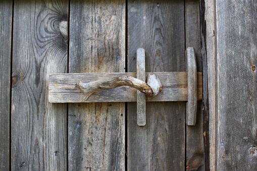 Rural door latch on a wooden door.