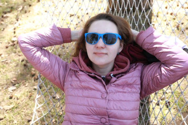 istock Woman lying in hammock in park 1499386928
