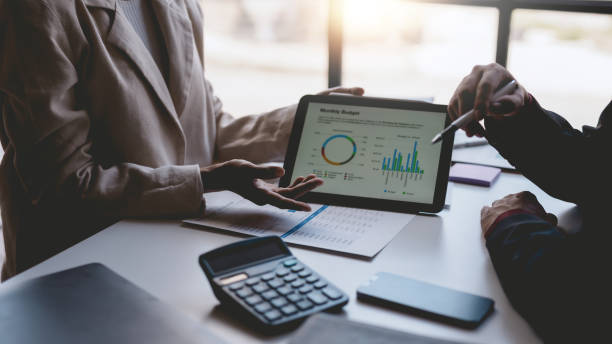 istock Business people meeting explaining the financial graph data and marketing plan on tablet. Group of business people at meeting assessment the state of business investment and marketing. 1499388743