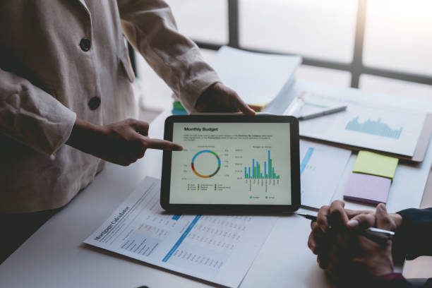 istock Business people meeting explaining the financial graph data and marketing plan on tablet. Group of business people at meeting assessment the state of business investment and marketing. 1499388745