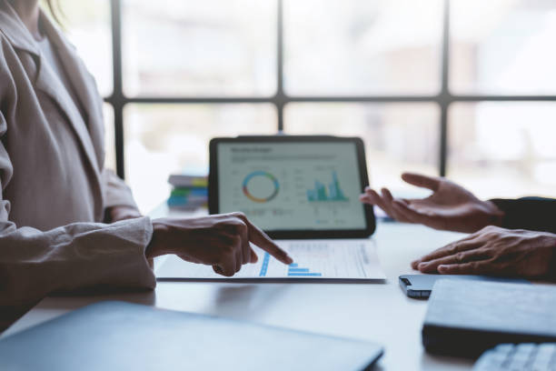 istock Business people meeting explaining the financial graph data and marketing plan on tablet. Group of business people at meeting assessment the state of business investment and marketing. 1499388748