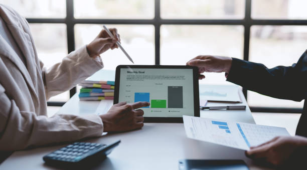 istock Business people meeting explaining the financial graph data and marketing plan on tablet. Group of business people at meeting assessment the state of business investment and marketing. 1499388769