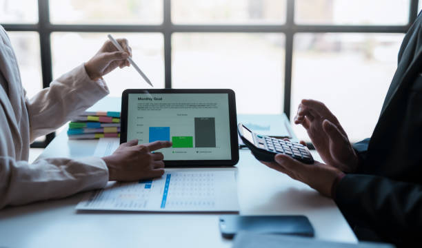 istock Business people meeting explaining the financial graph data and marketing plan on tablet. Group of business people at meeting assessment the state of business investment and marketing. 1499388770