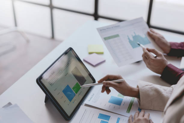 istock Business people meeting explaining the financial graph data and marketing plan on tablet. Group of business people at meeting assessment the state of business investment and marketing. 1499388789