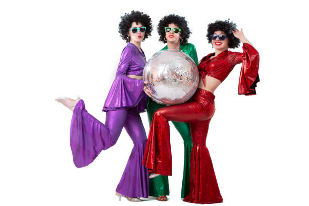 istock A group of girls in multi-colored disco-style costumes pose on a white background. 1499391462