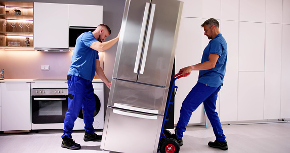 Delivery And Install Of Refrigerator Appliance. Mover Carrying Fridge