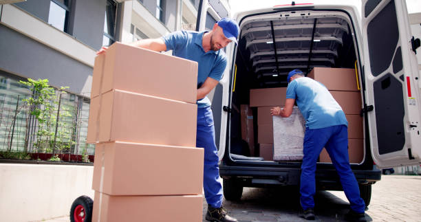 istock Two Young Male Movers Carrying Cardboard Box 1499392529