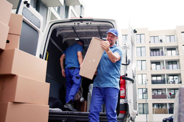 istock Two Young Male Movers Carrying Cardboard Box 1499392813