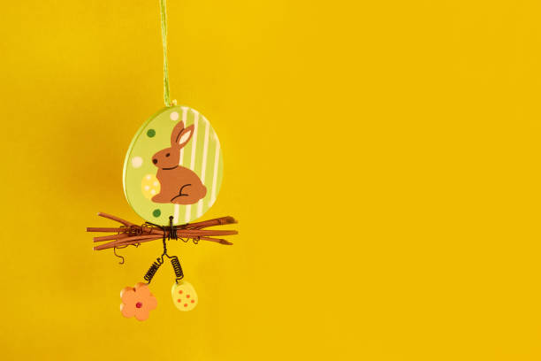 istock Easter beauty with a hanging rabbit on a yellow background. Easter celebration. 1499394997