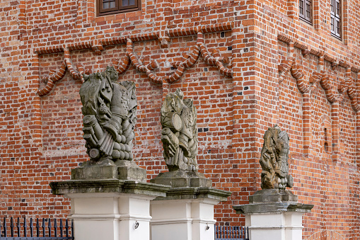 Szczecin, Poland - September 16, 2022: Sculptures above the entrance gate to medieval Ducal Castle (Szczecin Castle)