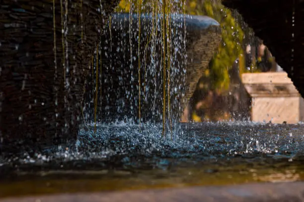 Close Up Rushing Water Sprays Falling Forcefully From The Multi-tiered Structure Of The Fountain Into The Pool