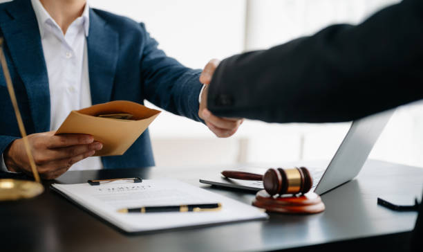 istock Man lawyer hand and women client shaking hand collaborate on working agreements with contract documents at the modern office. 1499401567