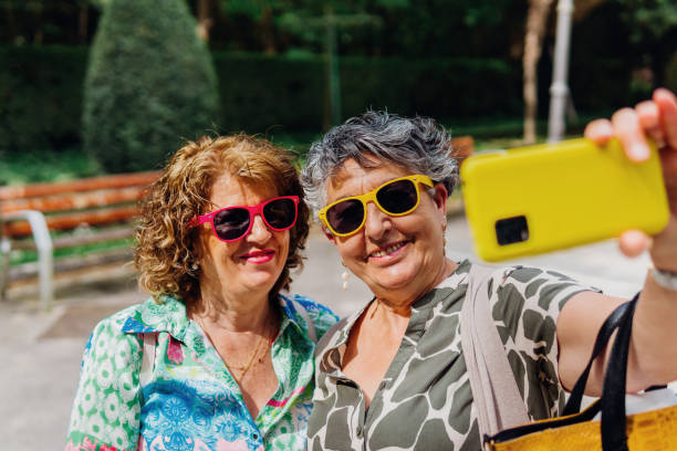 istock Modern mature women with sunglasses taking a selfie 1499402237