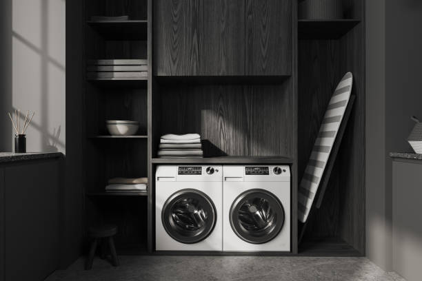 istock Grey interior of laundry room with washing machine and iron board 1499402937