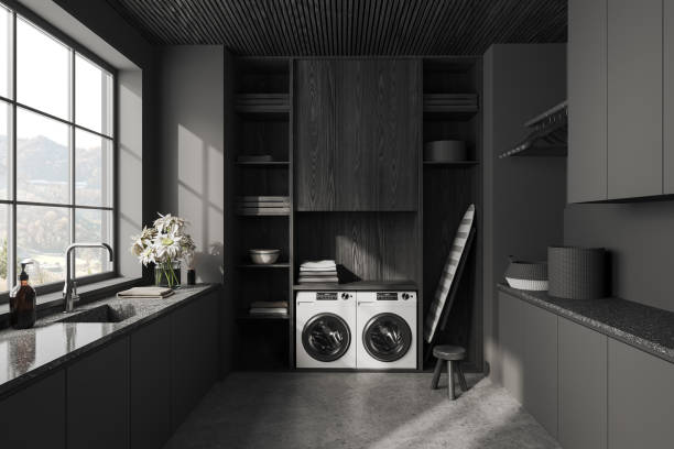 istock Grey interior of laundry room with washing machine and iron table 1499404918