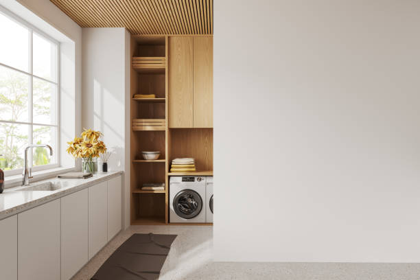 istock White wall interior of laundry room, washing machine and window. Mock up wall 1499405274