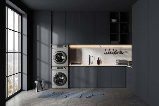 istock Laundry interior with black shelves, washing machines and panoramic window 1499405557