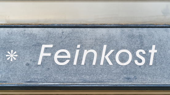 Lettering Feinkost above the entrance to a shop in the old town of Goslar in Germany. Translation: delicacies
