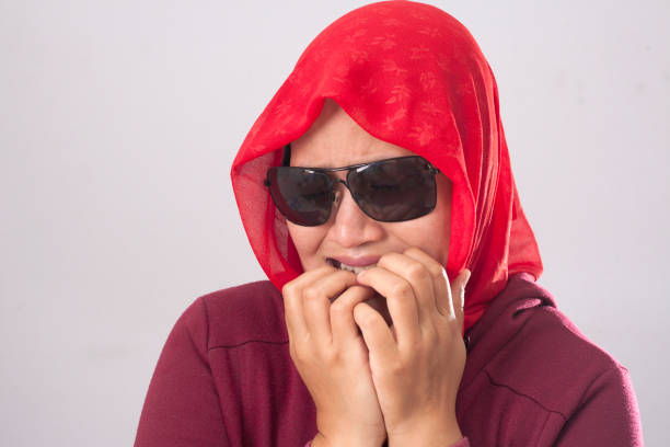 istock Worried Muslim Lady in Red Biting Nails 1499409616