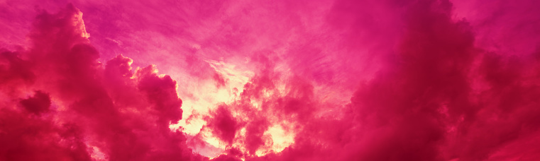 Beautiful purple pink magenta cloudy sky at sunset. Sky texture, abstract nature background. Horizontal banner
