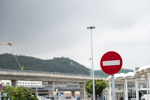 Multiple traffic signs with blue sea in background