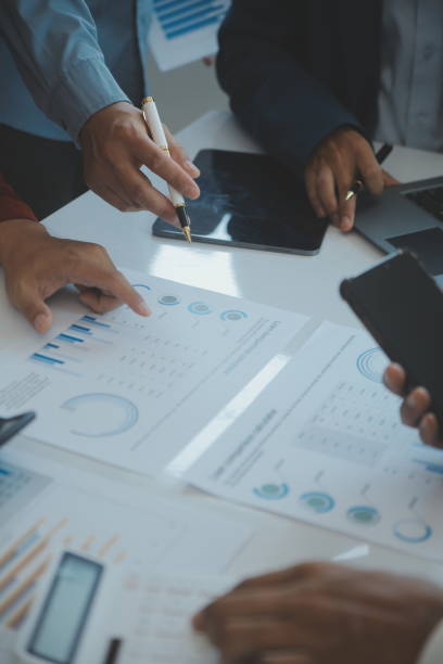 istock Financial analysts analyze business financial reports on a digital tablet planning investment project during a discussion at a meeting of corporate showing the results of their successful teamwork. 1499414287