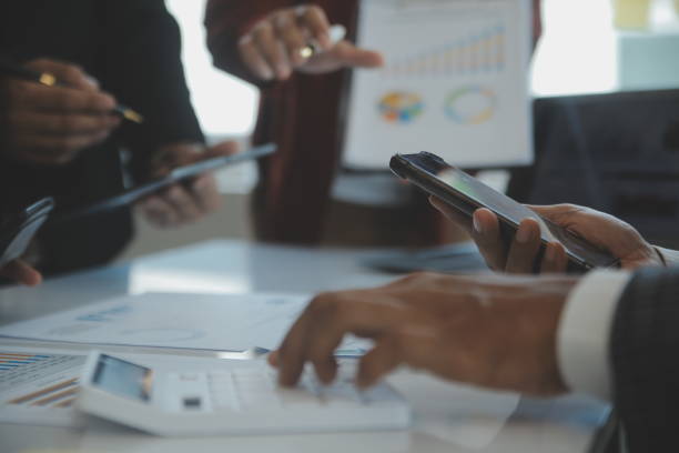istock Financial analysts analyze business financial reports on a digital tablet planning investment project during a discussion at a meeting of corporate showing the results of their successful teamwork. 1499414312