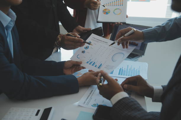 istock Financial analysts analyze business financial reports on a digital tablet planning investment project during a discussion at a meeting of corporate showing the results of their successful teamwork. 1499414337
