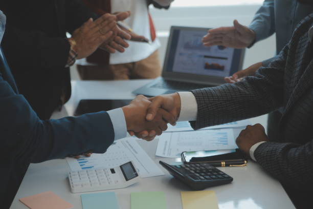 istock Success Teamwork Concept, Business people joining hands city background. 1499414365