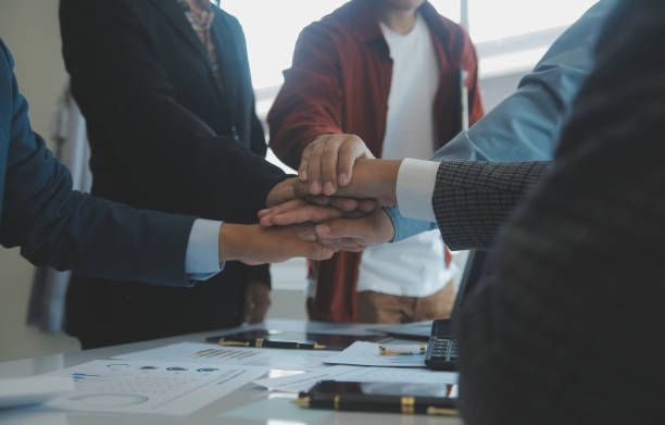 istock Success Teamwork Concept, Business people joining hands city background. 1499414383