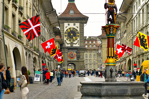 Bern-May 20 ,2023 :Old town view with tourists and Zytglogge clock tower in Kramgasse street in Bern Switzerland