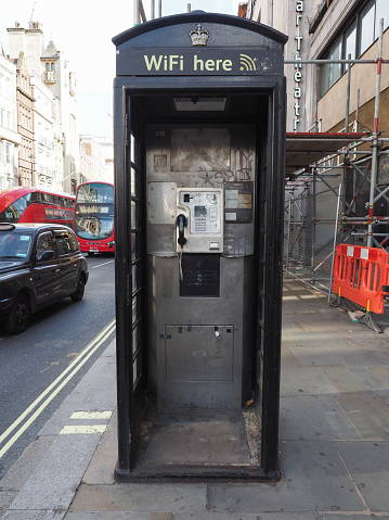 London, UK - June 06, 2023: Vintage black public telephone box repurposed with wifi