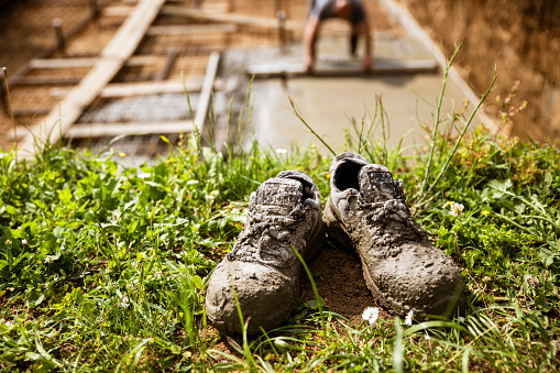 Dirty shoes. Sneakers smeared with dirty soil.