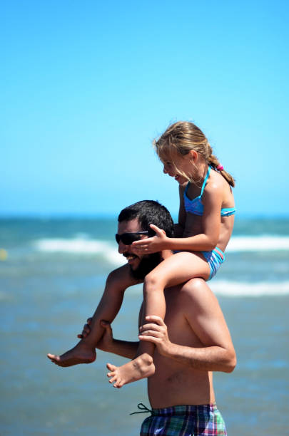 istock Father and daughter spend a happy moment on the beach 1499417254