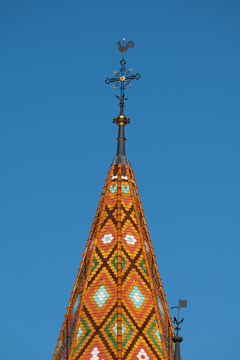 Detail of the tiled roof and spire of Matthias Church in Budapest, Hungary