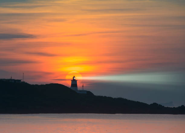 istock Fans of wind turbines spin over the sparkling sea. Dynamic clouds at sunset. 1499420696