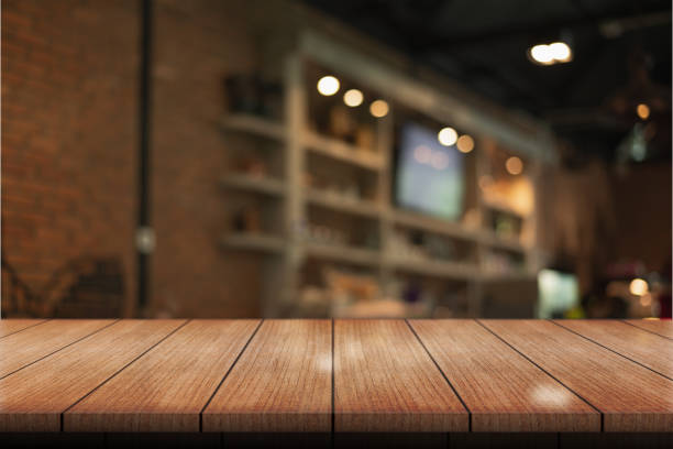 istock Empty wooden table top with lights bokeh on blur restaurant background. 1499423045