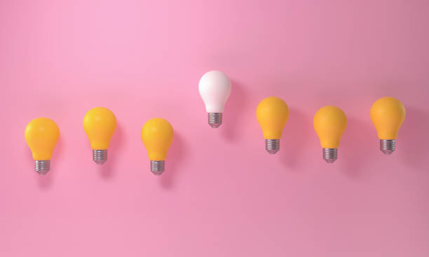 istock Light bulb outstanding among yellow lightbulb group on pink background. Innovation unique think different. 1499423860