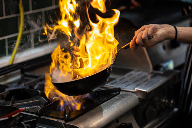 istock Chef Working in the Kitchen, Delicious Meal Prepared in Flames, Chef's Special 1499431584