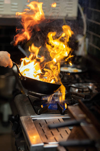 istock Chef Working in the Kitchen, Delicious Meal Prepared in Flames, Chef's Special 1499431615