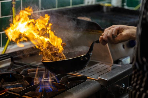 istock Chef Working in the Kitchen, Delicious Meal Prepared in Flames, Chef's Special 1499431661