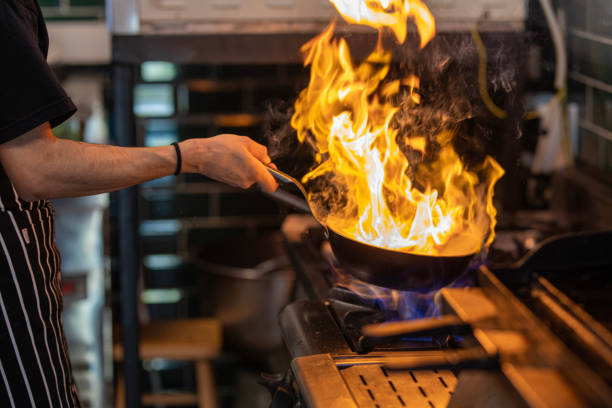 istock Chef Working in the Kitchen, Delicious Meal Prepared in Flames, Chef's Special 1499431689
