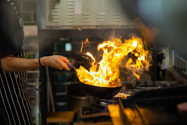 istock Chef Working in the Kitchen, Delicious Meal Prepared in Flames, Chef's Special 1499431717