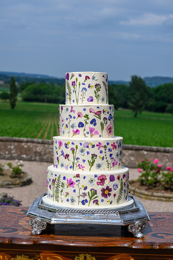 Four tier wedding cake with pressed flowers