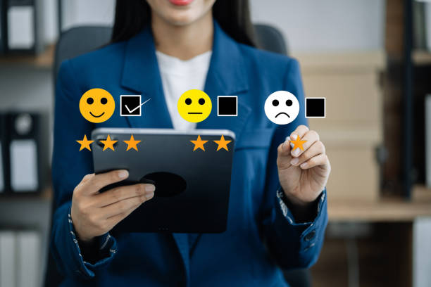 istock Woman holding a digital tablet and smartphone with checkboxes rating smiley faces excellent for Satisfaction Survey, Happy Client Customer Experience concept. 1499433459